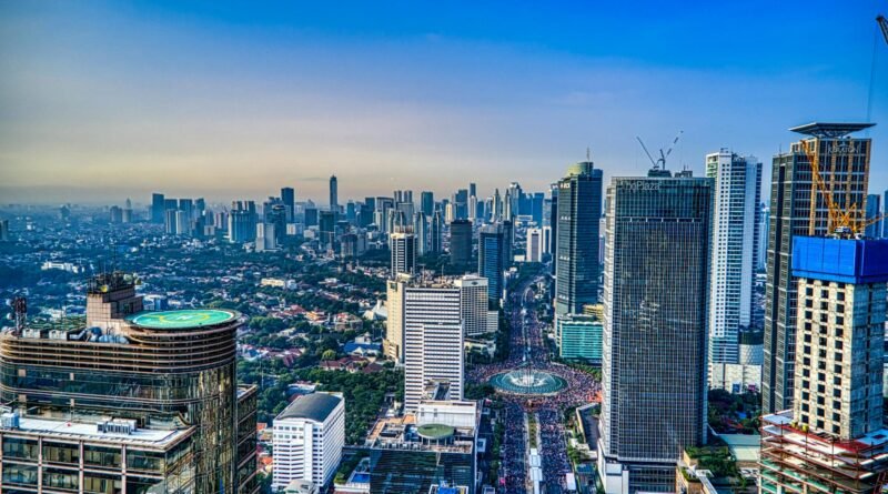 A breathtaking aerial view of Jakarta's urban skyline during the day, showcasing skyscrapers and city life.
