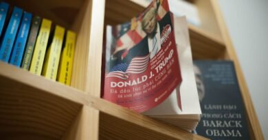 A close-up view of a bookshelf with books featuring political leaders in a bookstore setting.